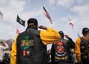 Group of Vietnam Veterans saluting the American flag